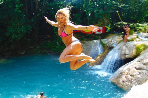 Girl jumping into Blue Hole.